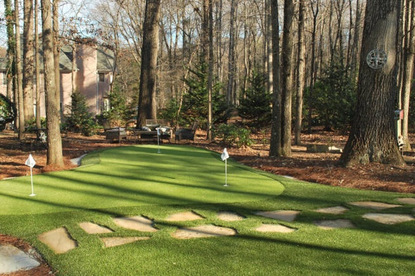 Oakley backyard putting green with flags and trees